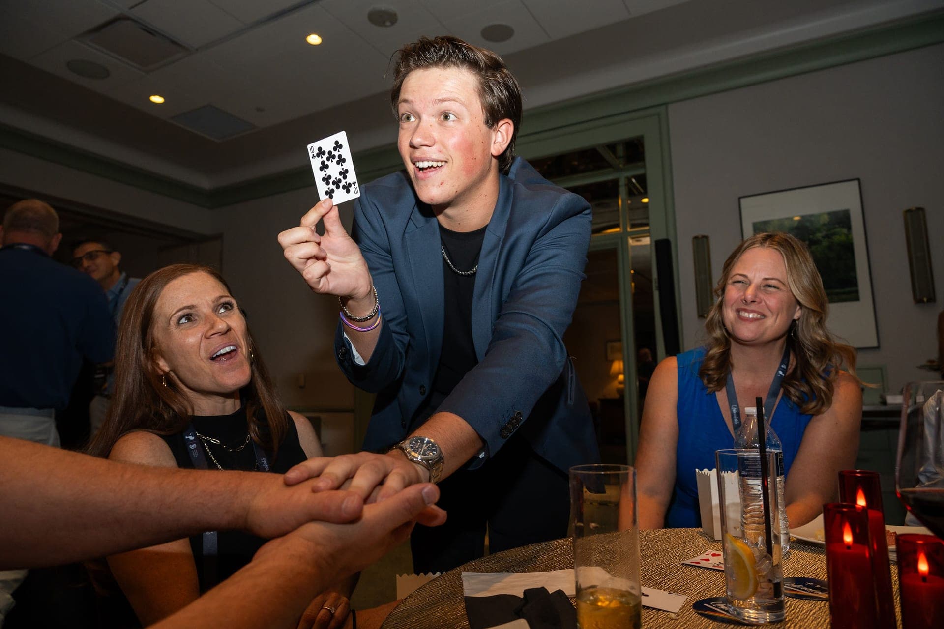 Geno performing close-up magic at a corporate event